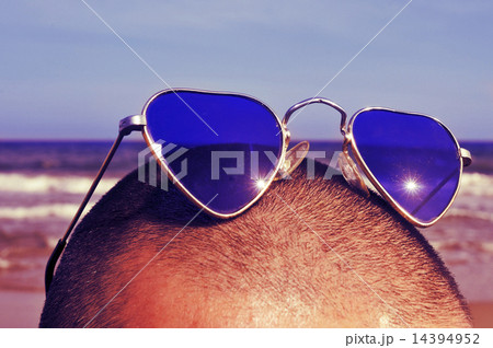 man with heart-shaped sunglasses on the beach, with a retro effe man with heart-shaped sunglasses on the beach, with a retro effe 14394952