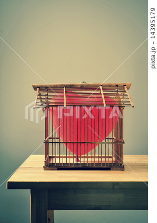 heart-shaped balloon in an old birdcage heart-shaped balloon in an old birdcage 14395179