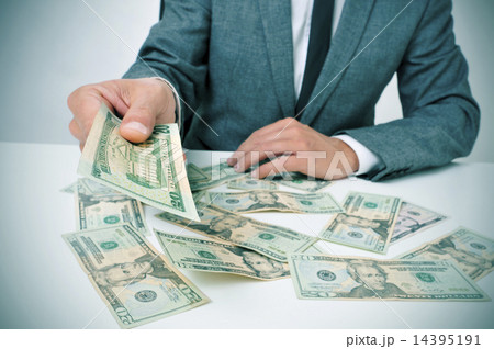 man in suit giving dollar bills 14395191