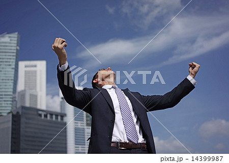 Caucasian man raising his arms to celebration 14399987