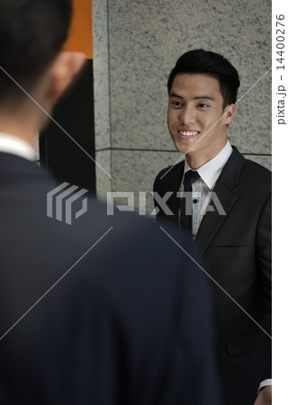Friendly young man pressing the lift and showing hospitality Friendly young man pressing the lift and showing hospitality 14400276