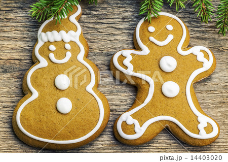 Christmas gingerbreads on a wooden table with fir  14403020