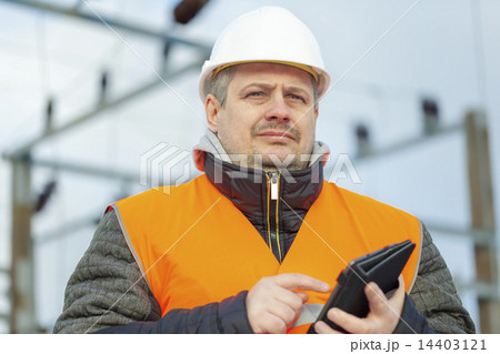 Electrical Engineer with tablet PC in the electric Electrical Engineer with tablet PC in the electric 14403121