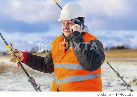 Electrical Engineer talking on cell phone near ten 14403123