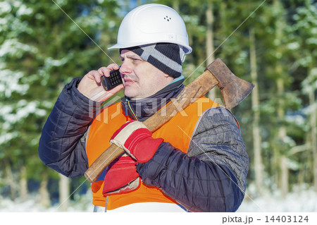 Lumberjack in the forest in winter with an ax  14403124