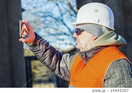 Construction employee filmed with tablet PC  14403207