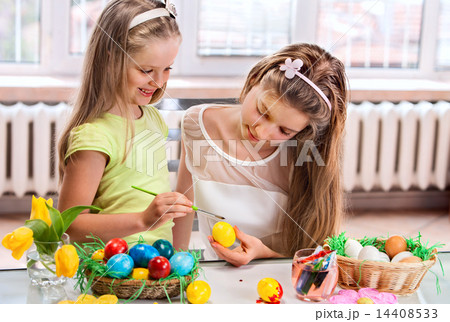 Children paint Easter eggs at home. 14408533