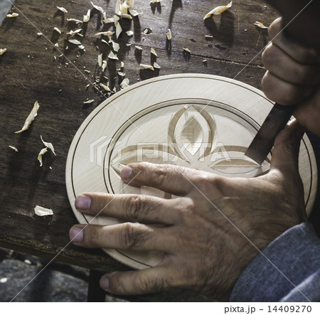 Hands of woodcarver make wooden bowl Hands of woodcarver make wooden bowl 14409270