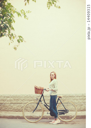 Young blonde woman on a vintage bicycle 14409315