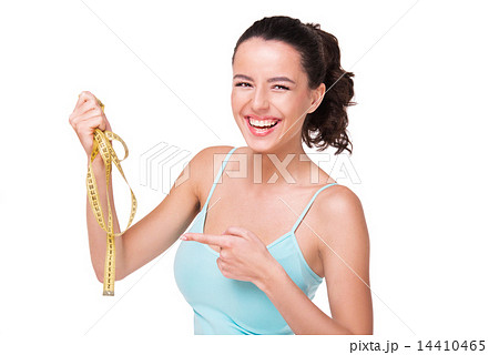 Young woman pointing at measure tape 14410465