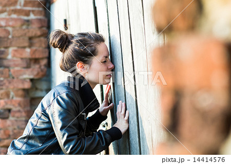 A young woman looking into the old building A young woman looking into the old building 14414576