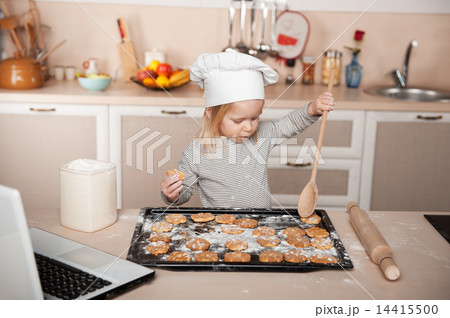 Little cute girl preparing cookies Little cute girl preparing cookies 14415500
