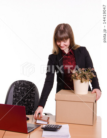 Adopted at work in office girl puts things out of box Adopted at work in office girl puts things out of box 14419047