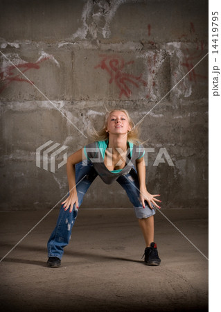 Beautiful hip hop girl dancing over grey brick wall 14419795