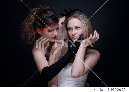 Closeup portrait of two girls: good & evil Closeup portrait of two girls: good & evil 14420095