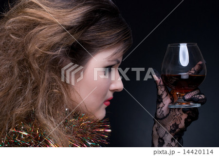 Closeup portrait of girl with red lips, tinsel and wineglass on Closeup portrait of girl with red lips, tinsel and wineglass on 14420114