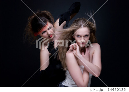 Closeup portrait of two girls: good & evil Closeup portrait of two girls: good & evil 14420126