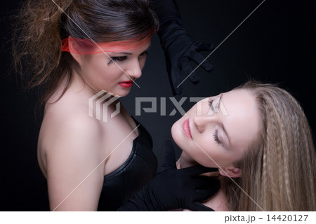 Closeup portrait of two girls: good & evil 14420127