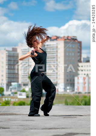 Beautiful girl dancing hip-hop over urban landscape Beautiful girl dancing hip-hop over urban landscape 14420285
