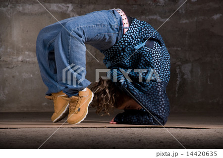 Hip hop dancer in modern style over brick wall Hip hop dancer in modern style over brick wall 14420635