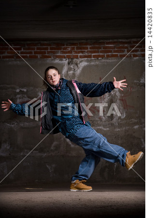 Hip hop dancer in modern style over brick wall Hip hop dancer in modern style over brick wall 14420835