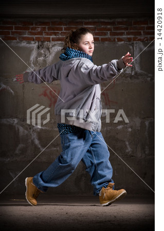 Hip hop dancer in modern style over brick wall 14420918