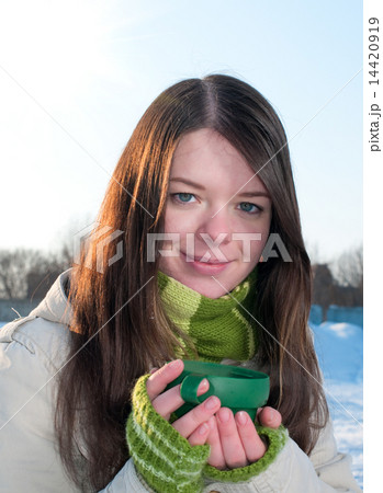 Girl on winter picnic with cup of hot tee Girl on winter picnic with cup of hot tee 14420919