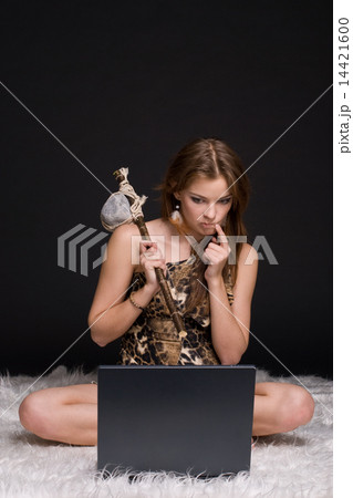 Closeup portrait of young savage woman with stone hammer and not Closeup portrait of young savage woman with stone hammer and not 14421600