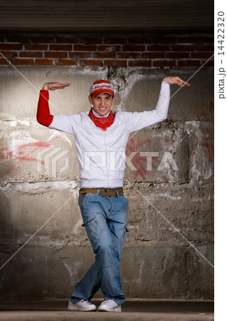 Hip hop boy dancing in modern style over grey brick wall Hip hop boy dancing in modern style over grey brick wall 14422320