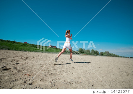 Sport woman running in sea coast 14423077