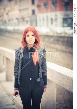 young beautiful red hair venezuelan woman lifestyle listening mu 14424106