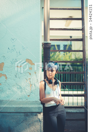 young beautiful short blue hair hipster woman with headphones mu 14424151