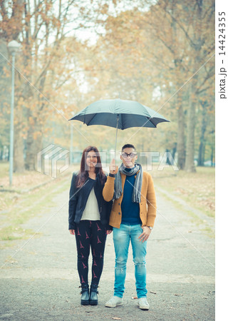 young couple in the park during autumn season outdoor 14424355