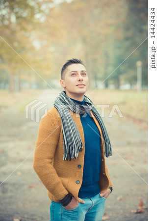 young handsome caucasian man in autumn park young handsome caucasian man in autumn park 14424434