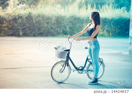 young beautiful brunette straight hair woman using bike 14424657