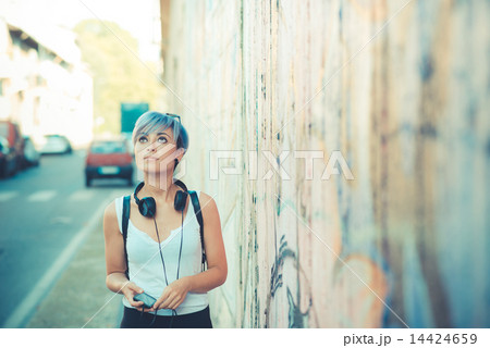 young beautiful short blue hair hipster woman with headphones mu 14424659