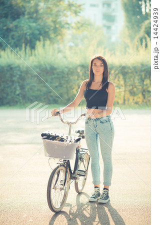 young beautiful brunette straight hair woman using bike 14424939