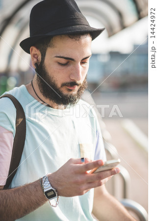 young handsome hipster gay modern man using smartphone 14424972