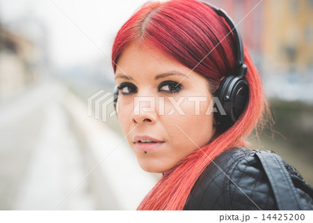 young beautiful red hair venezuelan woman lifestyle listening mu 14425200