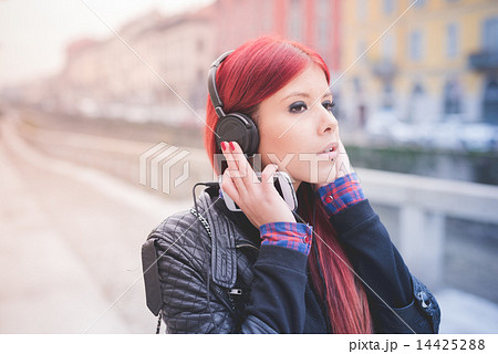 young beautiful red hair venezuelan woman lifestyle listening mu 14425288