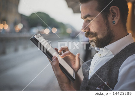 handsome big moustache hipster man using tablet 14425289