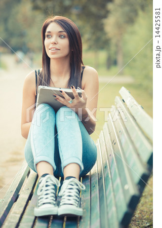 young beautiful brunette straight hair woman using tablet 14425581