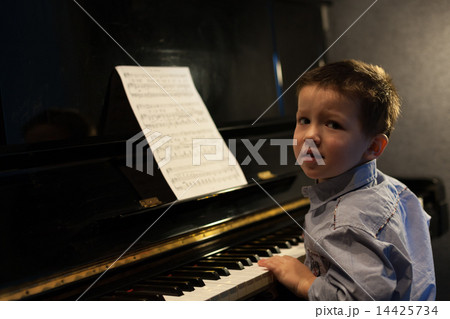 Portrait of a little boy learning piano 14425734
