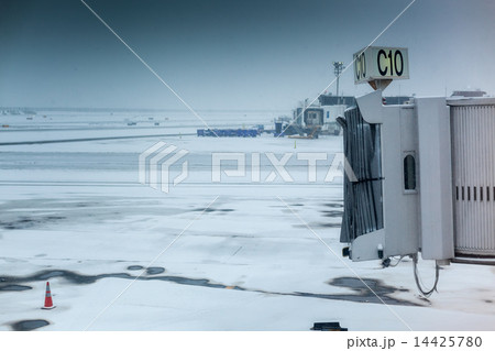 Empty airport aerobridge in winter weather at an airport 14425780