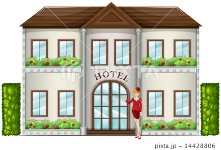 A hotel attendant standing in front of the hotel A hotel attendant standing in front of the hotel 14428806