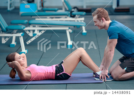 Beautiful girl in sports club with instructor 14438091
