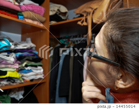 The girl in meditations before a wardrobe 14455014