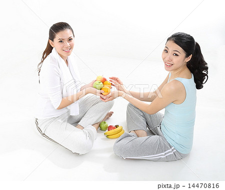 Two Woman sitting posing with fruit 14470816