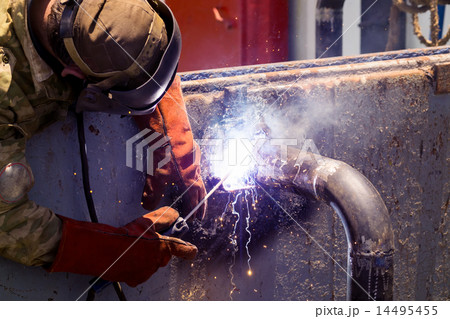 The welder welds the design of the pipes. The welder welds the design of the pipes. 14495455