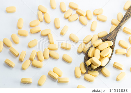 medicine tablets on a wooden spoon medicine tablets on a wooden spoon 14511888